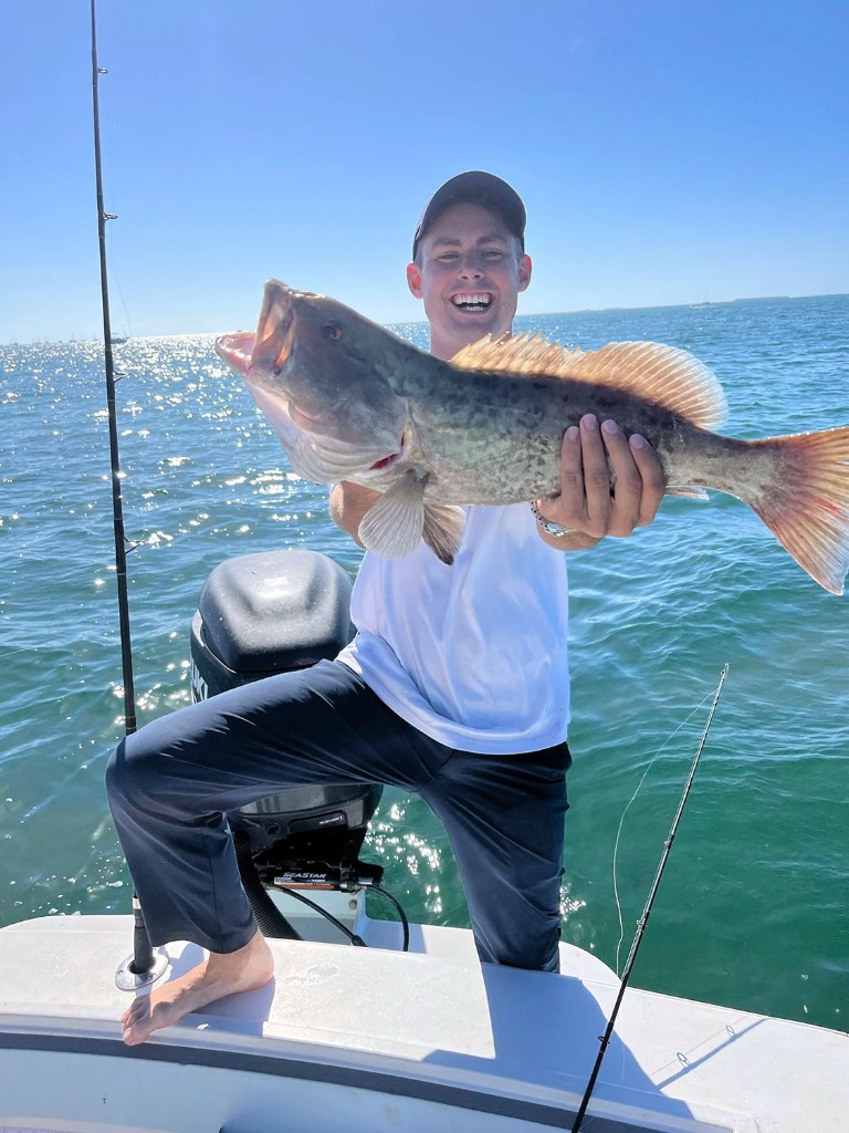 Angler holding a redfish on a Screaming Lines Charters fishing trip in Key West